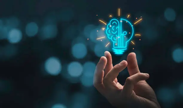 hand-holding-drawing-virtual-lightbulb-with-brain-on-bokeh-background-for-creative-and-smart[1]
