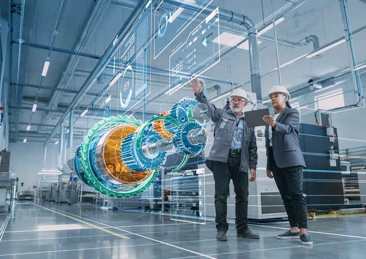 Factory Digitalization: Two Industrial Engineers Use Tablet Computer, Visualize 3D Model of Clean Green Energy Engine. Industry 4 High-Tech Electronics Facility with Machinery Manufacturing Products
