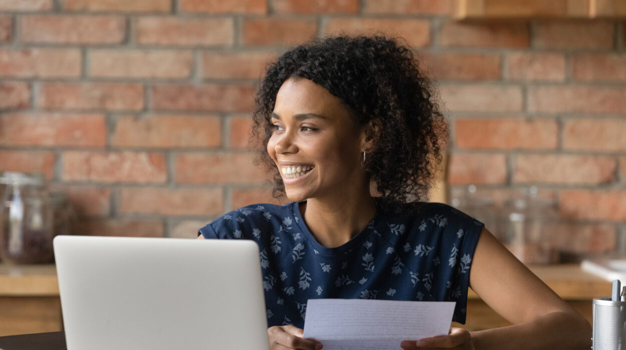 Happy millennial Black student girl receiving paper letter, invitation