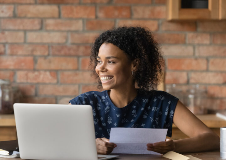 Happy millennial Black student girl receiving paper letter, invitation